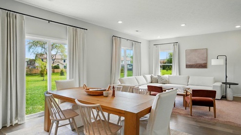 Dining room off of the living room featuring a wooden table and 6 chairs