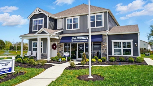 Front exterior of a Stamford model home featuring blue and gray siding