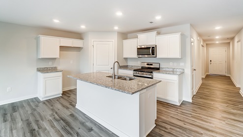 kitchen with white cabinets and built in island