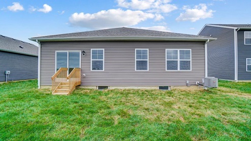 single story home with tan siding rear exterior