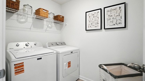 laundry room with wire shelving, washer and dryer