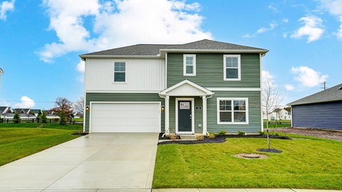 two story home with white and green siding, covered entry and two car garage