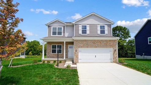 Two story home with tan siding, partial stone front, covered front porch, two car garage_Pendleton