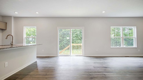 Interior living area with large windows open to kitchen