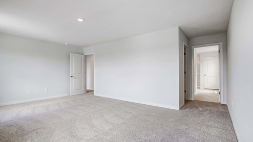 Interior primary bedroom open to primary bathroom