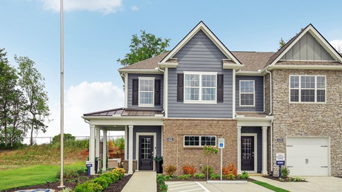 Two story end unit townhome exterior with grey or blue elevation options and brick or stone accents