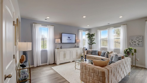 Open concept living and dining room in modern two story townhome.