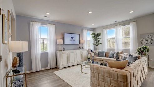 Open concept living and dining room in modern two story townhome.