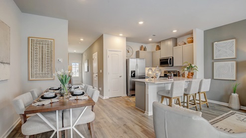Living room in new, open-concept townhome connected to the kitchen
