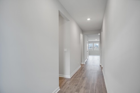 Front entryway with light brown flooring and light walls.