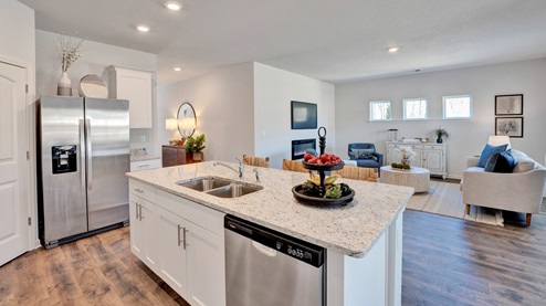 the kitchen island overlooks all main living areas of the home