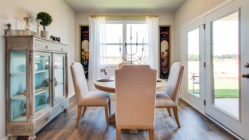 bristol plan dining area with windows facing to the back yard and sliding doors to the covered patio in riverwood gardens community