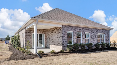 rear view of dover model with full brick exterior and spacious yards