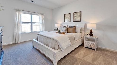 Primary bedroom with a large double window for natural light