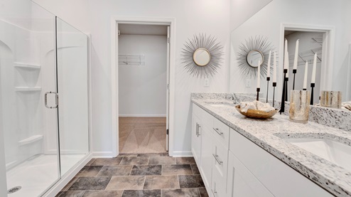 EN suite primary bathroom with a granite counter top vanity