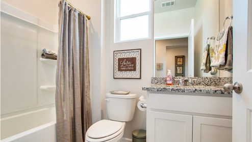 Second bathroom with a single vanity and an acrylic tub/shower insert