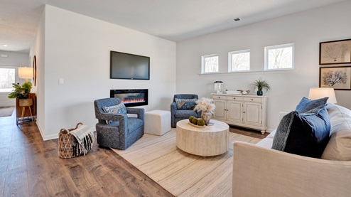 Living room area opens up at the end of long entry hall