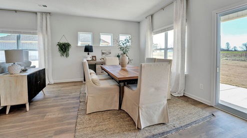 Dining area with close access out to covered patio