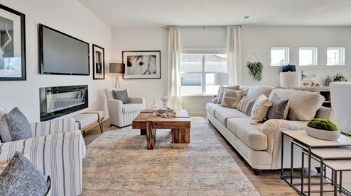 Living room with a large backwall window overlooking the side yard