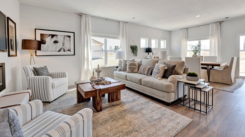 Living room open concept view opens up at the end of entry hall