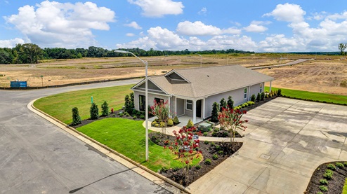 Drone view of the beautifully landscaped model home yard
