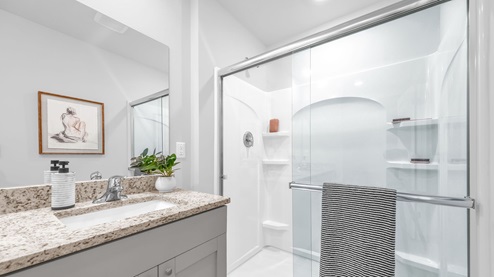 Glass enclosed walk in shower in primary bathroom