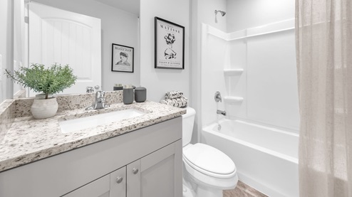 Second bathroom with a single vanity and an acrylic tub/shower insert