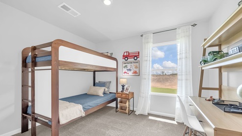 Fourth bedroom with a tall window overlooking the backyard
