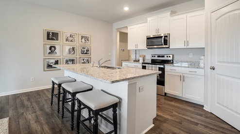 Kitchen area with granite countertops and a corner walk in pantry