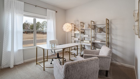 Second bedroom sitting at the front of the home with a large double window overlooking the front yard