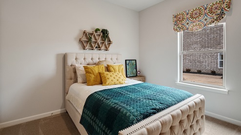 Fourth bedroom with a window overlooking the side yard