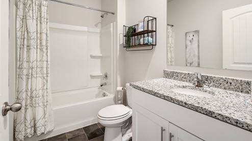 Second bathroom with a single vanity and an acrylic tub/shower insert