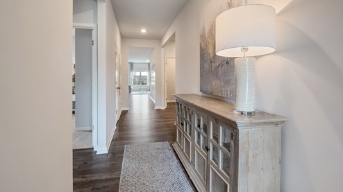 Front door entryway of the cali floorplan leading down the long entry hall