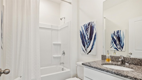 Secondary bathroom with a single vanity and tub-shower combo.