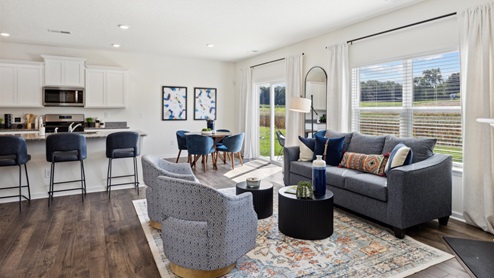 View of the home's entertaining space, comprised of a kitchen, dining area, and living room.