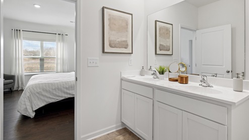 primary bathroom with white vanity and wall art