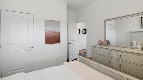 bedroom with wall art and dresser
