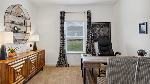 bedroom with desk and two chairs