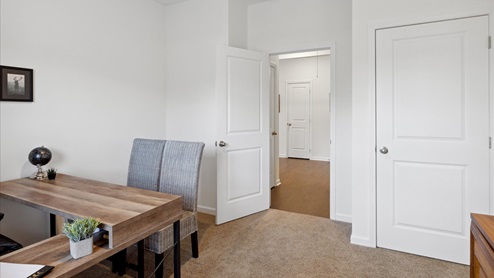 white bedroom with desk and chair