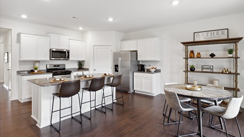 Modern kitchen with white cabinets and kitchen table