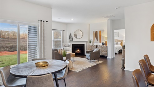 dining room with view into living room with fireplace