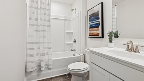 hall bathroom with white vanity and shower