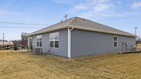 rear exterior of home with blue vinyl siding