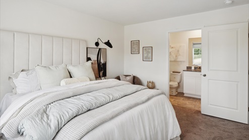 Primary Bedroom with carpet and white walls