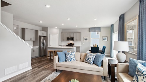 Open concept main level with living room and kitchen areas.