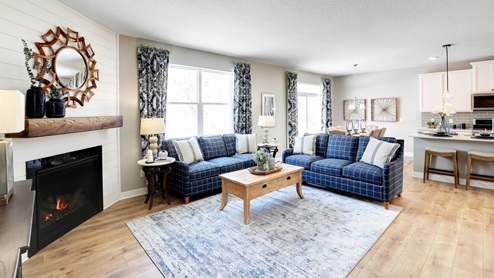 Living room with hard flooring and corner gas fireplace.