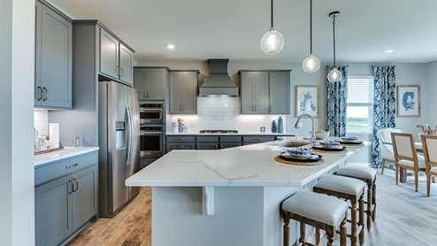 Gourmet kitchen with wood hood and gas stovetop.