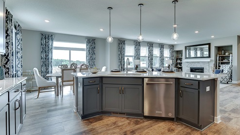 Angled island with built in stainless steel dishwasher.