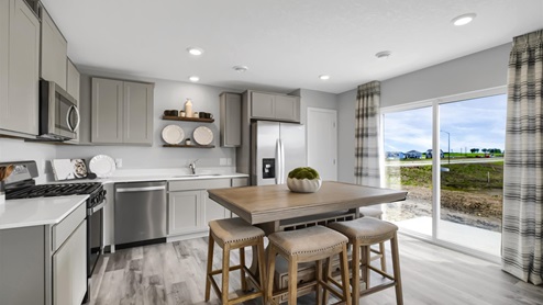 Kitchen with gray cabinets and stainless steel appliances.