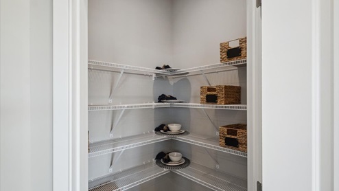 Pantry with plenty of shelves for storage.